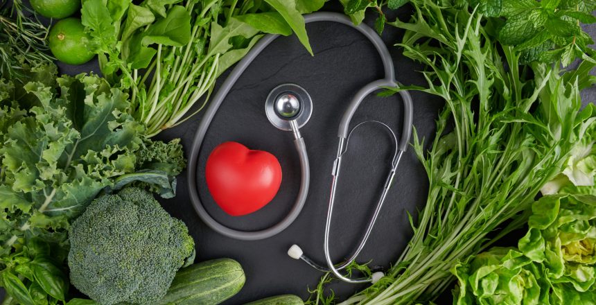 Background healthy food for heart. Healthy food, diet and life. Fresh fruits and vegetables, Healthy heart concept. green organic vegetarian products with heart near stethoscope.